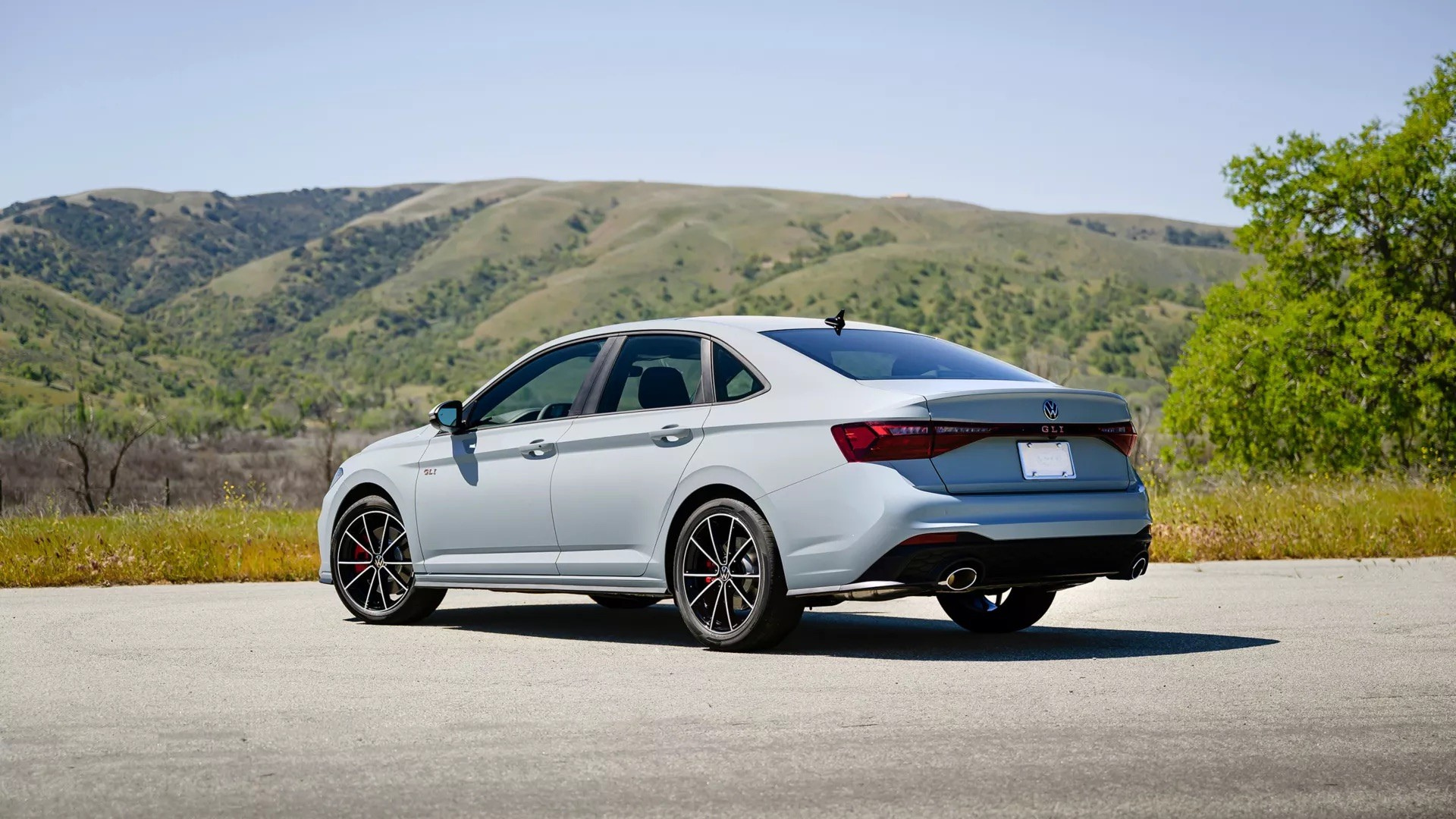 2026 Volkswagen Jetta GLI rear three-quarter view showing sport diffuser and dual exhaust tips